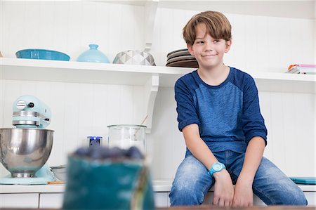 photos of blueberries for kitchen - Boy sitting on kitchen work surface Stock Photo - Premium Royalty-Free, Code: 649-08840124