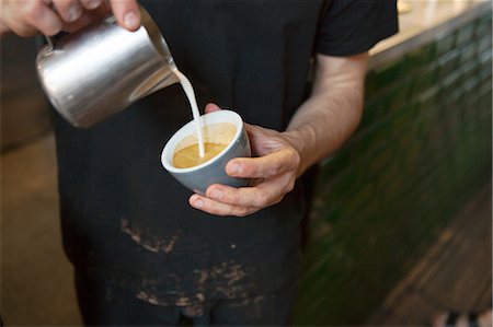 simsearch:614-06002323,k - Male barista's hands pouring milk into coffee cup in cafe Stock Photo - Premium Royalty-Free, Code: 649-08840273