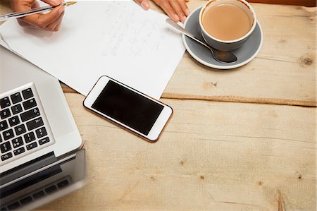 small business top view - Overhead view of female hands doing paperwork at cafe table Stock Photo - Premium Royalty-Free, Code: 649-08840282