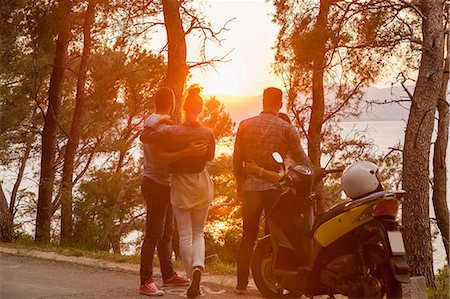 simsearch:649-08840317,k - Two moped couples looking out at sunset from coastal road, Split, Dalmatia, Croatia Photographie de stock - Premium Libres de Droits, Code: 649-08840319