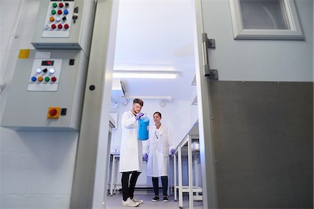 scientist white coat full body - View through doorway of scientists in laboratory Stock Photo - Premium Royalty-Free, Code: 649-08840376