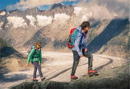 Couple climbing up ridge over Aletsch Glacier, Canton Wallis, Switzerland Stock Photo - Premium Royalty-Free, Code: 649-08840468