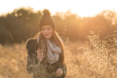 person nature not illustration and one person - Young woman in field, looking at smartphone Stock Photo - Premium Royalty-Free, Code: 649-08840543