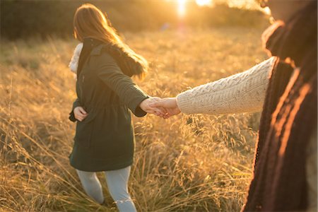 simsearch:649-09111242,k - Young couple walking through field, holding hands Stock Photo - Premium Royalty-Free, Code: 649-08840581