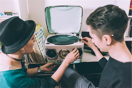 simsearch:649-08544187,k - Over shoulder view of two young women playing vinyl on vintage turntable Foto de stock - Sin royalties Premium, Código: 649-08840703