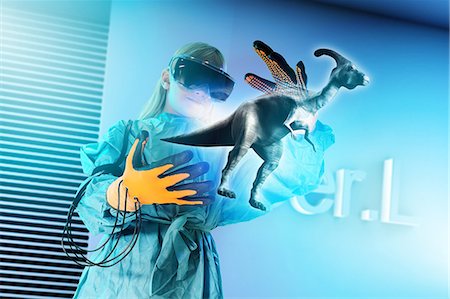 simsearch:649-08577535,k - Girl in virtual reality headset interacting with digital floating dinosaur Stock Photo - Premium Royalty-Free, Code: 649-08840755