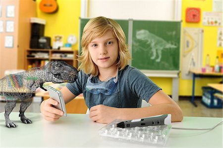 evoluzione - Portrait of boy with hand held computer and 3D model of tyrannosaurus rex Fotografie stock - Premium Royalty-Free, Codice: 649-08840764