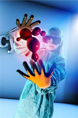 Girl in virtual reality headset interacting with digital floating blood globules Stock Photo - Premium Royalty-Free, Code: 649-08840760