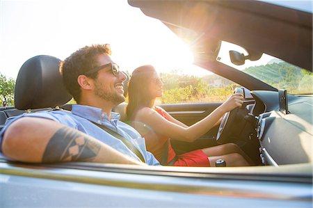 Young couple driving on sunlit rural road in convertible, Majorca, Spain Stock Photo - Premium Royalty-Free, Code: 649-08840803