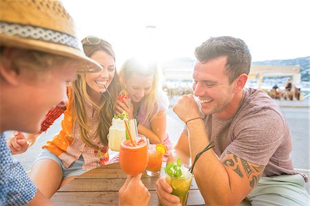 Two adult couples laughing over cocktails at waterfront restaurant, Majorca, Spain Stock Photo - Premium Royalty-Free, Code: 649-08840898