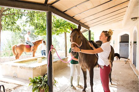 simsearch:649-08859547,k - Female grooms with horse at rural stables Stock Photo - Premium Royalty-Free, Code: 649-08859549