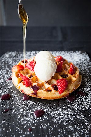 simsearch:649-08859789,k - Spoon pouring maple syrup over strawberries and ice cream waffle on slate Stock Photo - Premium Royalty-Free, Code: 649-08859798