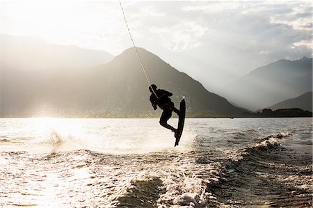 Silhouette of waterskier waterskiing, Maggiore lake, Verbania, Piedmont, Italy Stock Photo - Premium Royalty-Free, Code: 649-08860237