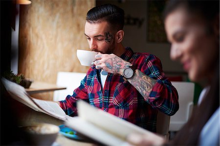 Couple drinking coffee reading newspapers Stock Photo - Premium Royalty-Free, Code: 649-08860268