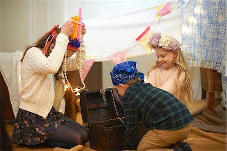 Boy and two sisters dressing up from treasure chest Stock Photo - Premium Royalty-Free, Code: 649-08894047