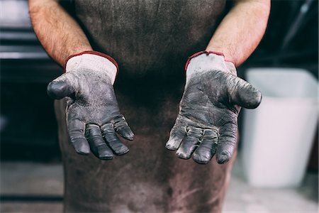 simsearch:649-08894144,k - Mid section of metalworker's protective gloves in forge workshop Stock Photo - Premium Royalty-Free, Code: 649-08894130