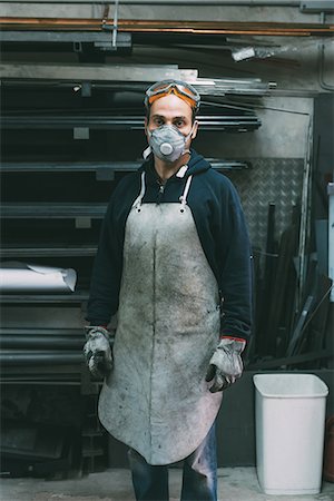 simsearch:649-08894144,k - Portrait of metalworker in dust mask in forge workshop Stock Photo - Premium Royalty-Free, Code: 649-08894141