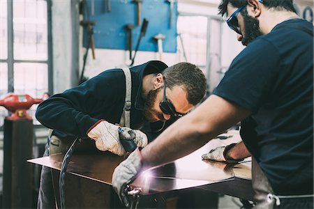 simsearch:649-08715047,k - Metalwork team cutting copper with welding torch in forge workshop Stock Photo - Premium Royalty-Free, Code: 649-08894143