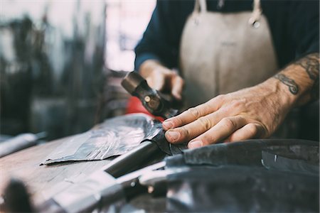 simsearch:649-08894144,k - Hands of metalworker hammering lead metal in forge workshop Stock Photo - Premium Royalty-Free, Code: 649-08894163