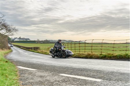 seniors motorcycle - Senior man and grandson riding motorcycle and sidecar on rural road Photographie de stock - Premium Libres de Droits, Code: 649-08894177