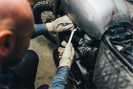 simsearch:614-09057420,k - Mature man, working on motorcycle in garage Stock Photo - Premium Royalty-Free, Code: 649-08894199