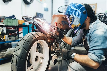 simsearch:614-09057420,k - Mature man, working on motorcycle in garage Stock Photo - Premium Royalty-Free, Code: 649-08894205