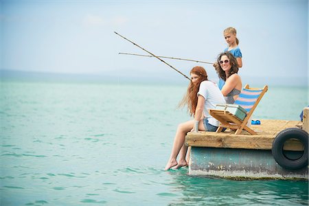 fishing pole in ocean pictures - Family fishing on houseboat deck, Kraalbaai, South Africa Stock Photo - Premium Royalty-Free, Code: 649-08894458