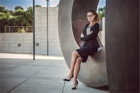 portrait confident women wearing glasses - Portrait of young businesswoman sitting outdoors, arms folded Stock Photo - Premium Royalty-Free, Code: 649-08894582