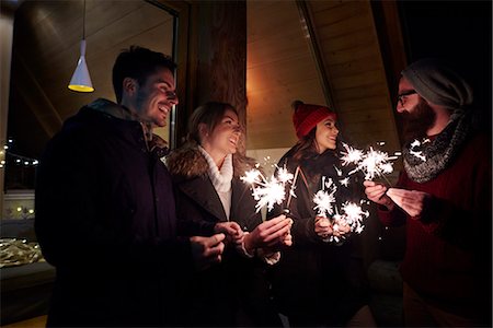 simsearch:649-08894657,k - Friends playing with sparklers by chalet Fotografie stock - Premium Royalty-Free, Codice: 649-08894665