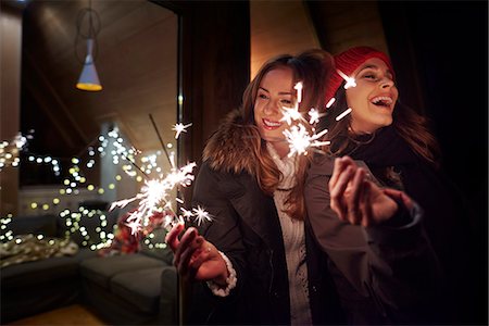 simsearch:649-08894657,k - Friends playing with sparklers by chalet Fotografie stock - Premium Royalty-Free, Codice: 649-08894666