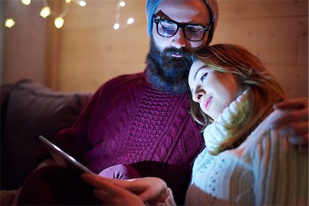 share home - Couple using digital tablet on sofa in chalet Stock Photo - Premium Royalty-Free, Code: 649-08894660