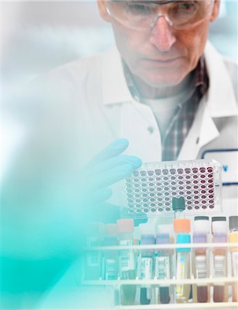 dna results - Scientist preparing blood samples in a multi well plate for clinical testing in a laboratory Stock Photo - Premium Royalty-Free, Code: 649-08894948