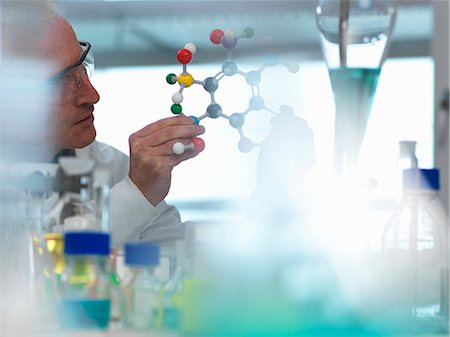 Researcher using a molecular model to understand a chemical formula in a laboratory Stock Photo - Premium Royalty-Free, Code: 649-08894956