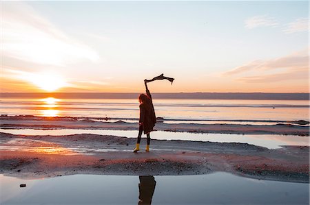 simsearch:649-09061376,k - Woman enjoying beach at sunset Stock Photo - Premium Royalty-Free, Code: 649-08893968