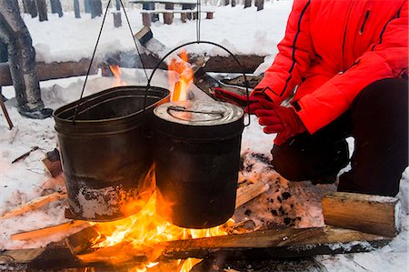 Cropped view of woman warming hands on campfire, Russia Stock Photo - Premium Royalty-Free, Code: 649-08893988