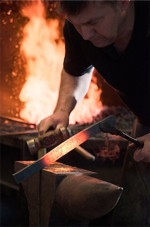fiery furnace - Farrier forging horseshoe on anvil Stock Photo - Premium Royalty-Free, Code: 649-08900553
