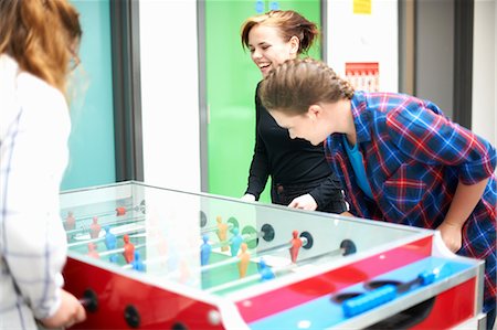 playing table soccer - Group of female friends playing table football Stock Photo - Premium Royalty-Free, Code: 649-08900621