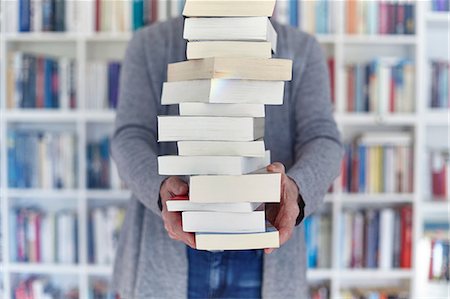 photo woman indoor - Woman holding stack of books, mid section Stock Photo - Premium Royalty-Free, Code: 649-08900652