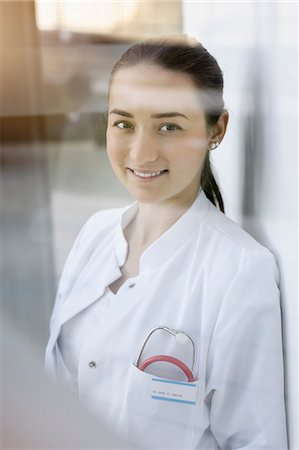 doctor wearing stethoscope - Portrait of female doctor, smiling Stock Photo - Premium Royalty-Free, Code: 649-08900684