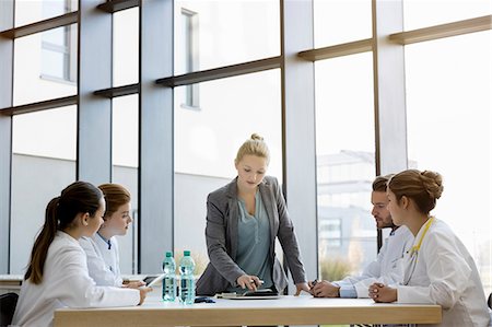 simsearch:649-08576616,k - Group of doctors in meeting with consultant Stock Photo - Premium Royalty-Free, Code: 649-08900696