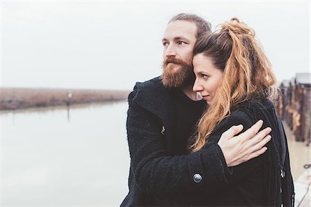 Couple hugging on misty canal waterfront Stock Photo - Premium Royalty-Free, Code: 649-08900788
