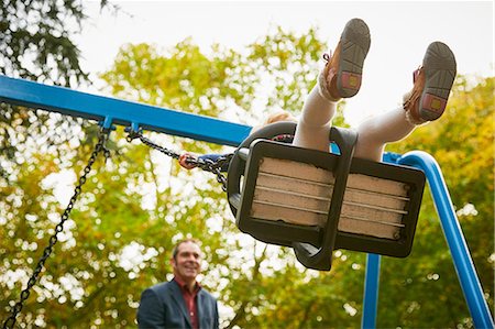 richmond park - Father pushing daughter on playground swing Stock Photo - Premium Royalty-Free, Code: 649-08901088