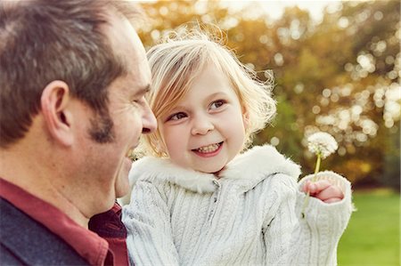 richmond park - Father carrying daughter holding dandelion clock Stock Photo - Premium Royalty-Free, Code: 649-08901106