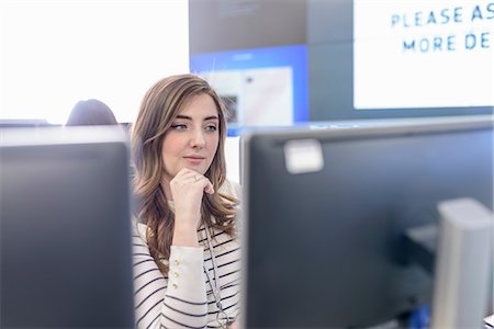Office worker directing social media in call centre in car factory Stock Photo - Premium Royalty-Free, Code: 649-08901127