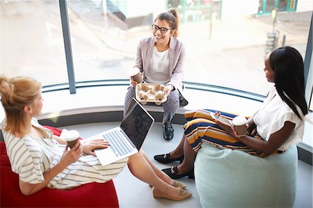 simsearch:649-08901059,k - Three businesswomen with takeaway coffee sitting on beanbags chatting Photographie de stock - Premium Libres de Droits, Code: 649-08901433