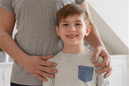 simsearch:649-08901538,k - Cropped portrait of boy with father's hands on shoulders Stock Photo - Premium Royalty-Free, Code: 649-08901536