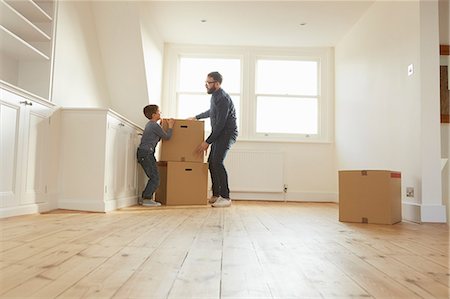 simsearch:649-08901538,k - Mid adult man and son stacking cardboard box in new home Stock Photo - Premium Royalty-Free, Code: 649-08901550