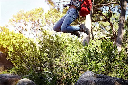 south africa forests - Young woman, wearing backpack, jumping in air, low section Stock Photo - Premium Royalty-Free, Code: 649-08901774