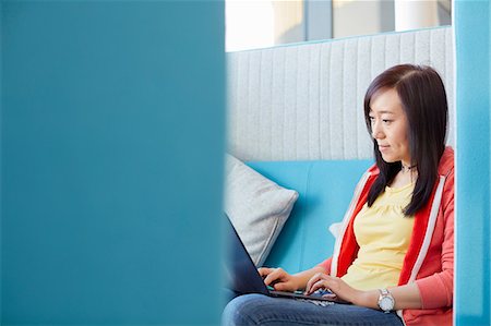 University student using laptop in modern cubicle Stock Photo - Premium Royalty-Free, Code: 649-08901935