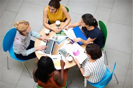 simsearch:673-06025373,k - High angle view of business women sitting at table in meeting Stock Photo - Premium Royalty-Free, Code: 649-08902027